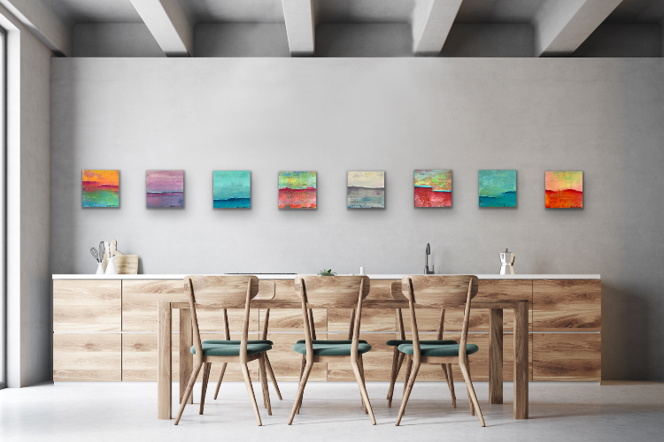 Eight colorful paintings with texture over kitchen sink with dining table. Creative art grouping for home decor.