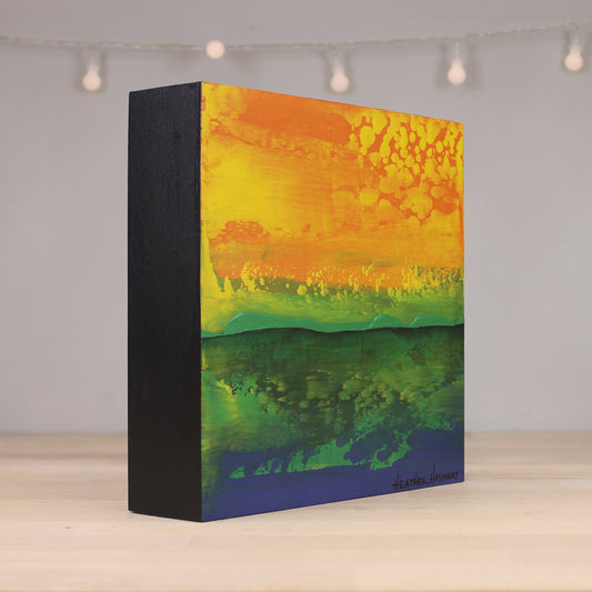 Abstract art canvas with orange, yellow, green, and blue colors on a black border.