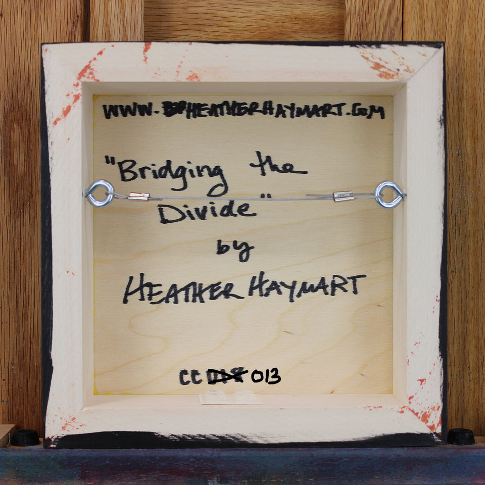 Back view of framed artwork with a wire, signed by Heather Haymart.