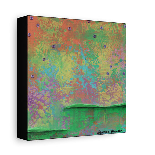 A square abstract canvas wall art print with a textured, multicolored background featuring shades of green, orange, yellow, purple, and blue, with a black side edge and a signature in the bottom right corner.