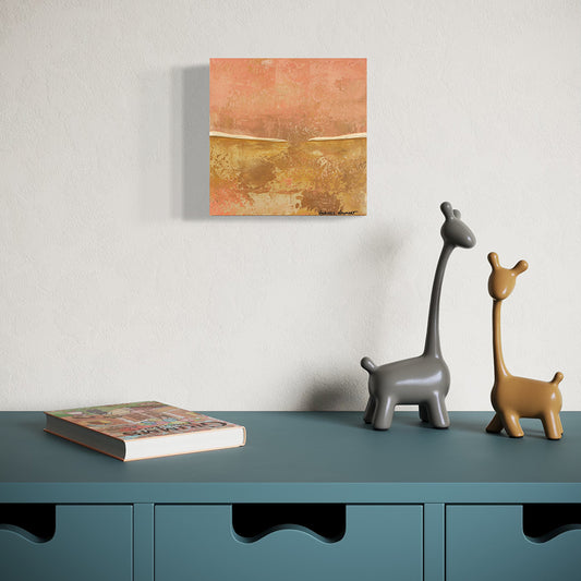 Two ceramic giraffe figurines on a teal surface with a painting on the wall.