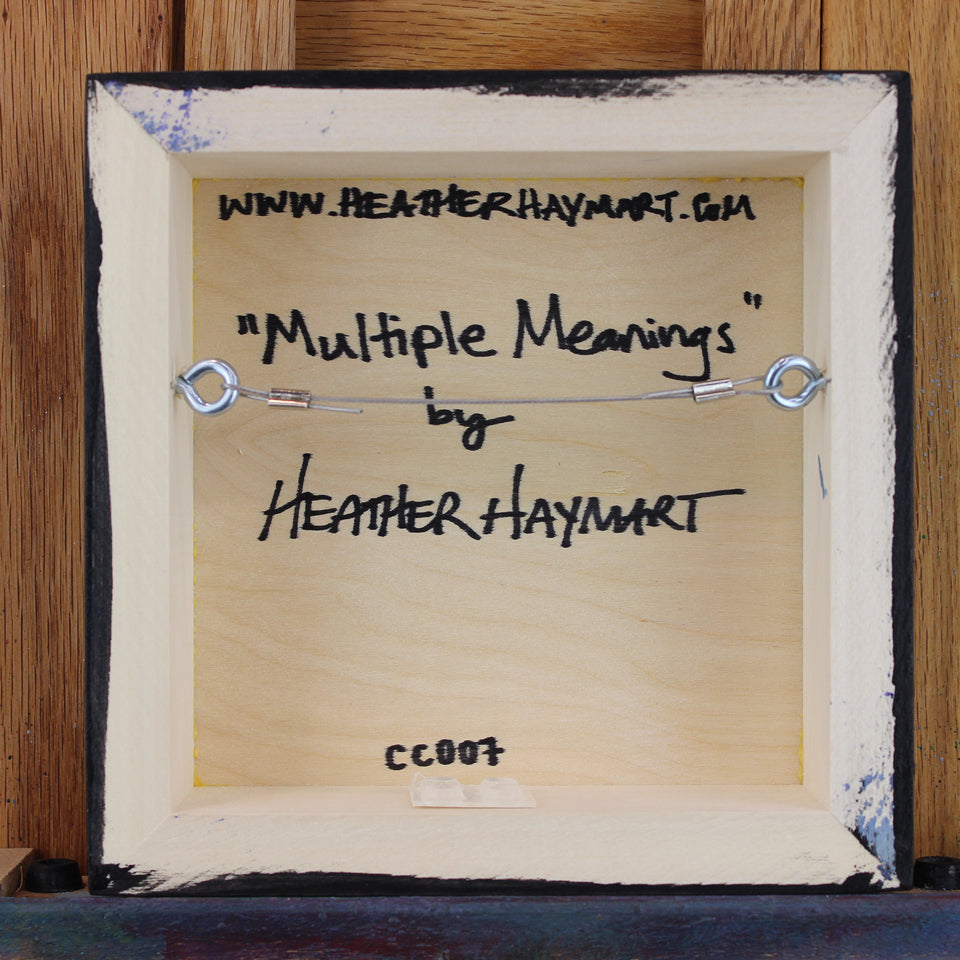 Back view of framed artwork with a wire, signed by Heather Haymart.