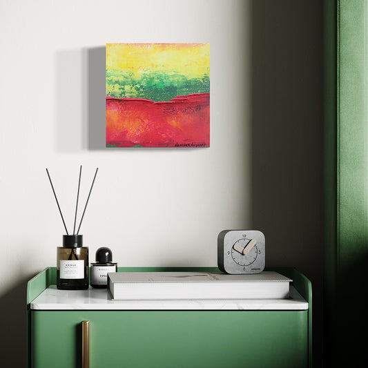 Colorful abstract painting on a wall above a green console table with decorative items.