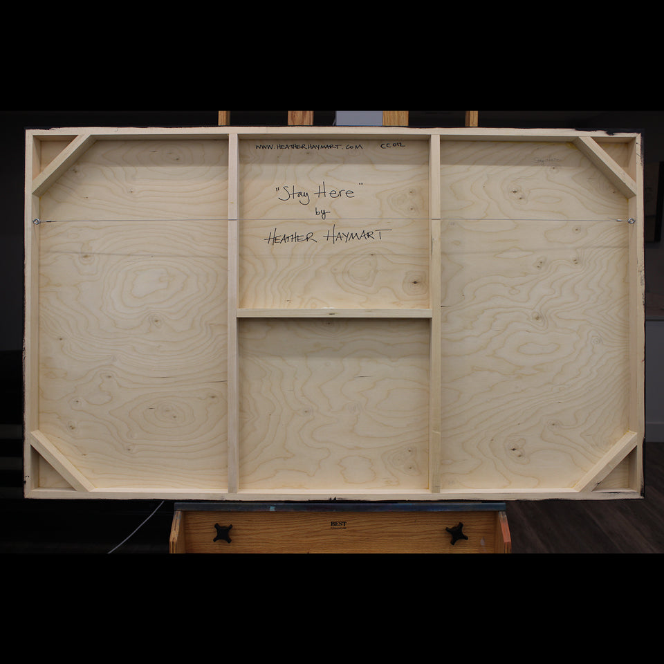 Back view of framed artwork with a wire, signed by Heather Haymart.