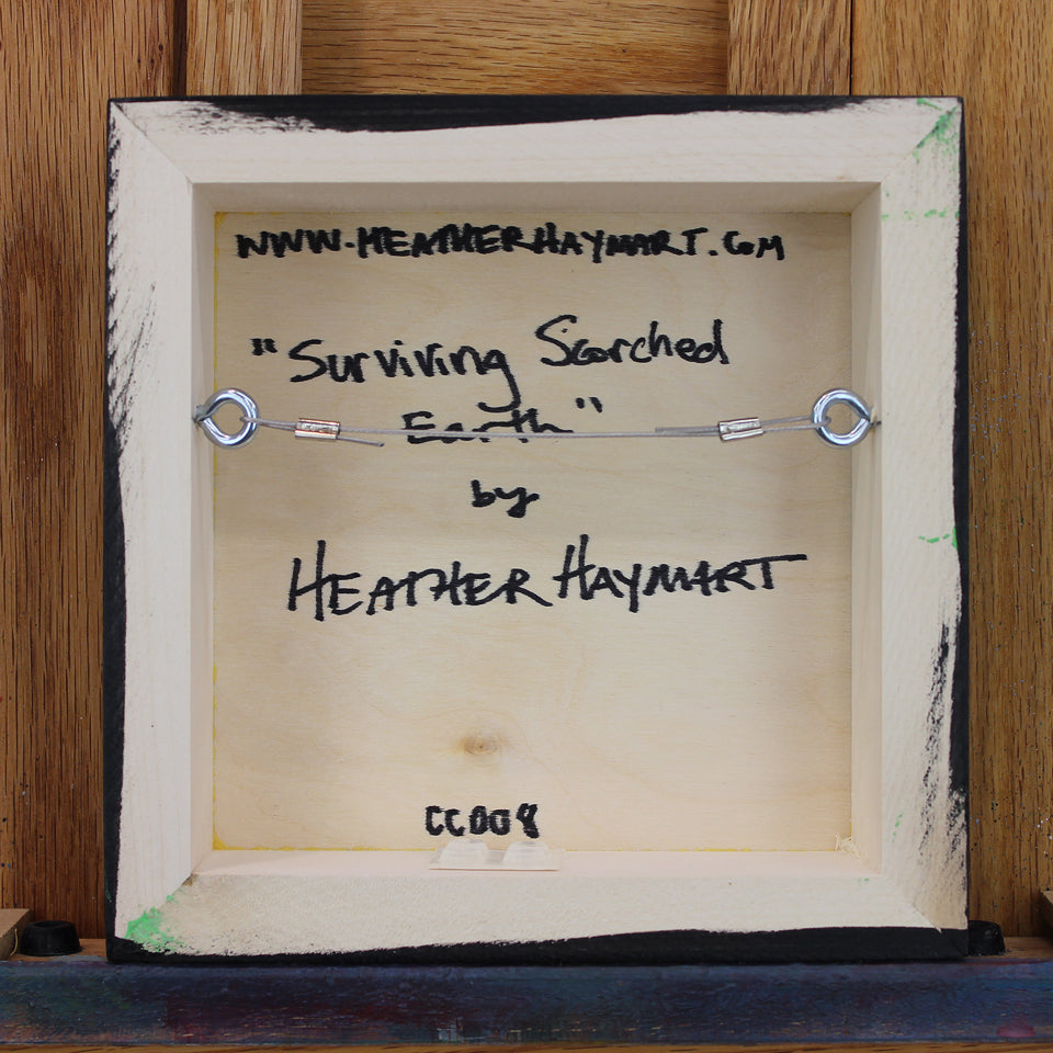 Back view of framed artwork with a wire, signed by Heather Haymart.