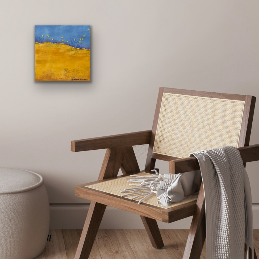 Blue and yellow abstract landscape painting on the wall with a chair