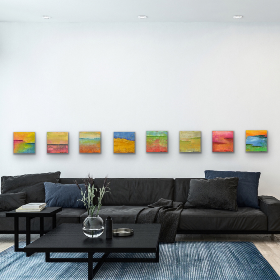 Eight pieces of fine art on the wall over dark gray couch