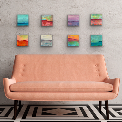 Eight colorful texture paintings over peach couch. Unique artwork grouping.