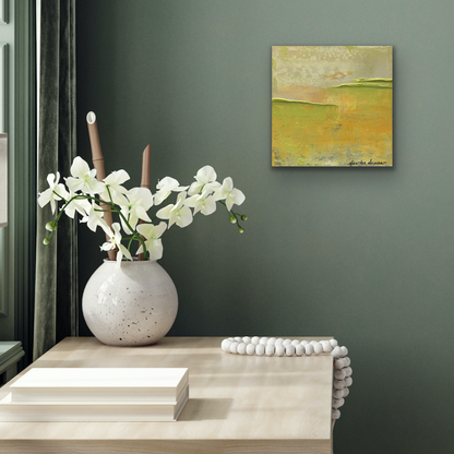 Abstract artwork on the wall over a table with flowers