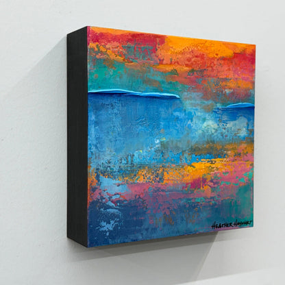 Abstract painting with vibrant colors on a white wall