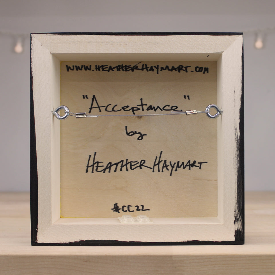 Wooden frame with 'Acceptance' by Heather Haymart text and website URL.