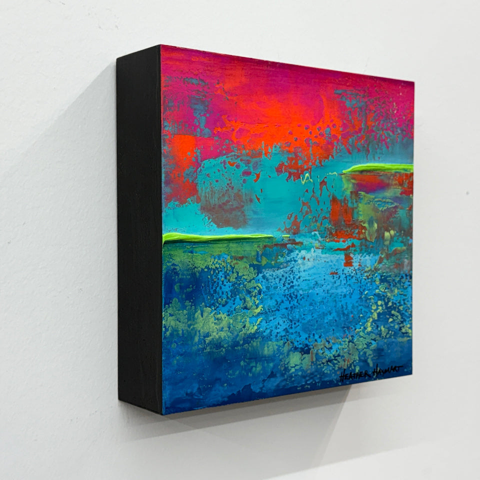 side view of Abstract art with vibrant colors on a white wall
