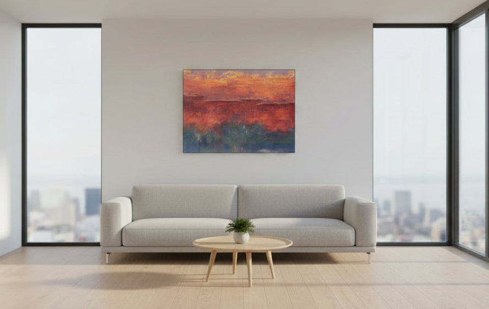 Abstract art print over couch with warm colors on a white background