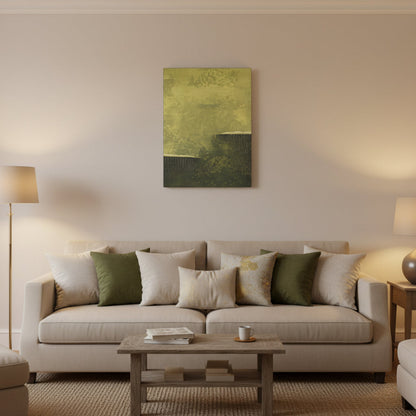 Abstract green painting on a wall above a desk with books and a lamp.