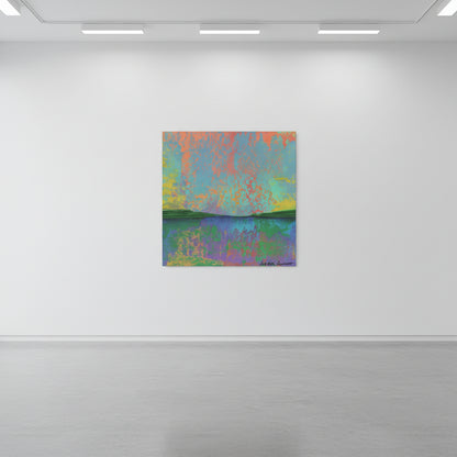 A square abstract wall art print with a colorful landscape-like design hangs on a white wall above a console table. The artwork features blended shades of blue, green, purple, orange, and yellow.