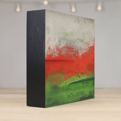 Abstract art piece with red, green, and gray colors on a black background