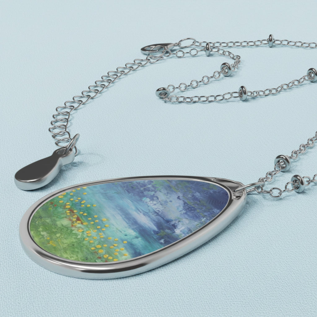 side view of blue and green art pendant and chain